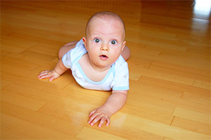 Baby Crawling on a clean timber floor