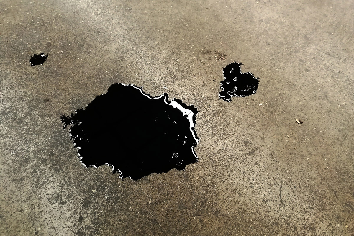 Black Oil leaked on to concrete